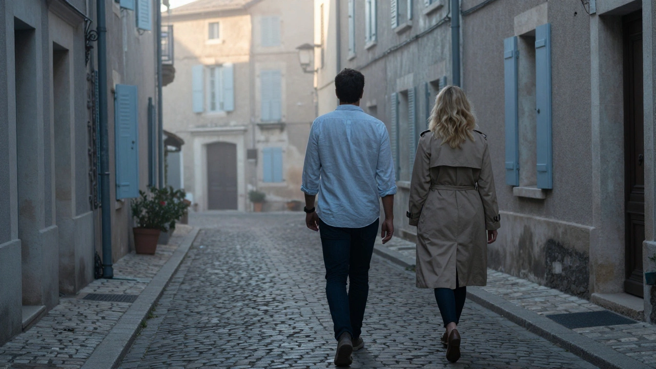 A man and woman walking quietly down a cobblestone alley in Aix at dawn, both dressed elegantly, misty atmosphere.